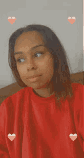 a woman in a red sweater with hearts around her