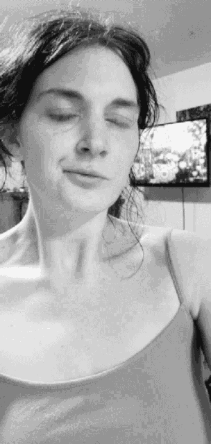 a black and white photo of a woman taking a selfie