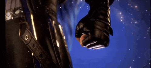 a close up of a person 's fist with a glove on .