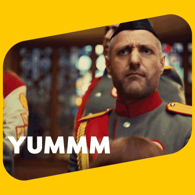 a man in a military uniform with the word yummm on the bottom right