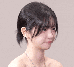 a close up of a woman 's face with a ponytail