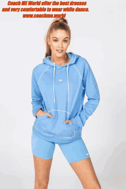 a woman is wearing a light blue hoodie and shorts