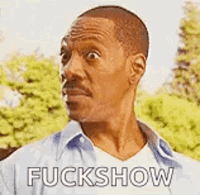 a man with a mustache is making a funny face and saying `` fuckshow '' .