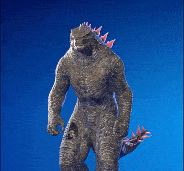 a statue of a monster with red spikes on its tail