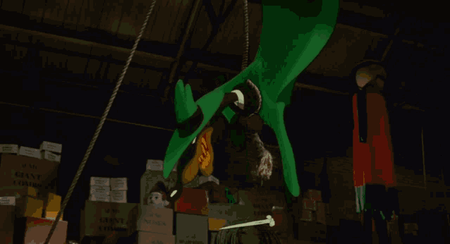 a cartoon character is hanging from a rope in a warehouse