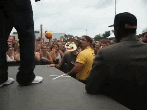a man in a suit stands in front of a crowd