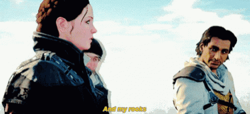 a man and a woman are standing next to each other .