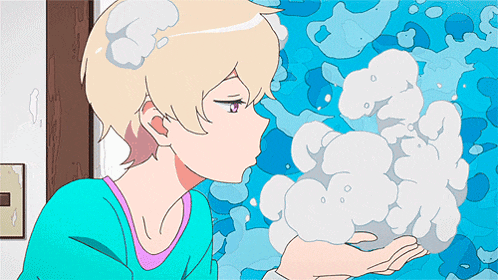 a girl blowing bubbles from her hand in front of a blue background