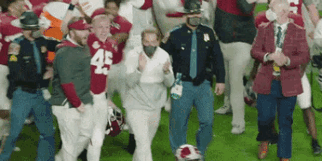a man wearing a jersey with the number 45 on it is surrounded by people