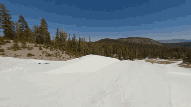 a ski slope with a yellow sign that says ' slope ' on it