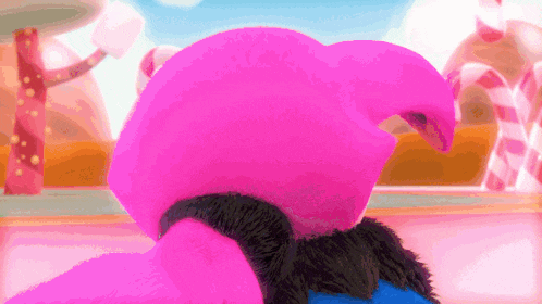 a pink stuffed animal is standing in front of some candy canes