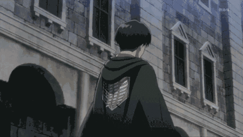 a man is standing in front of a brick building and says levi