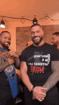 a group of men are standing next to each other in a room and smiling for the camera .
