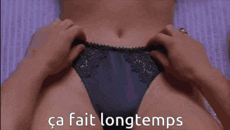 a shirtless man is laying on a bed with the words ca fait longtemps written on the bottom