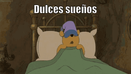winnie the pooh is laying in bed wearing a sleep mask .