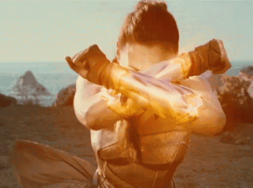 a woman with her arms crossed holds a sword in her hands