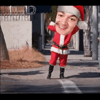 a man in a santa suit is crossing the street