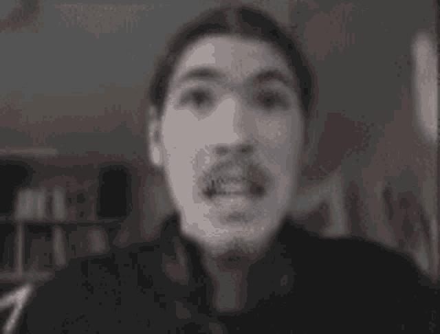 a blurry picture of a person 's face with a light coming out of it