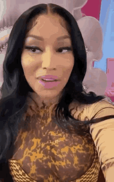 a woman with long black hair is taking a selfie in a room .