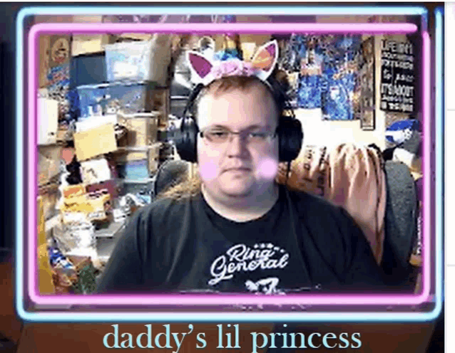 a man wearing headphones and a unicorn headband with the words daddy 's lil princess on the bottom