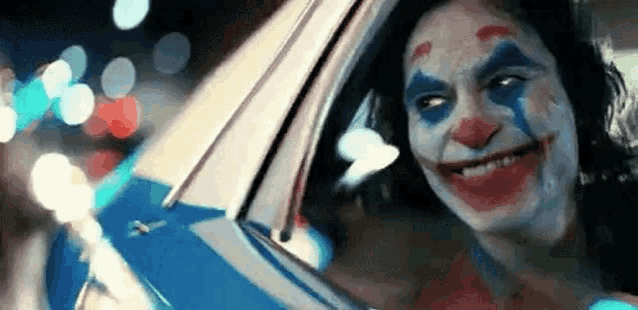 a close up of a clown in a car .