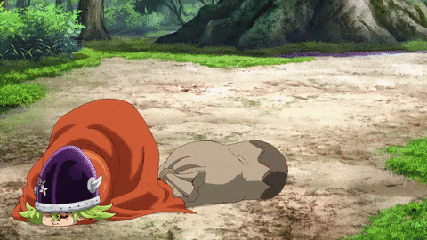 a cartoon character laying on the ground with a purple helmet on his head