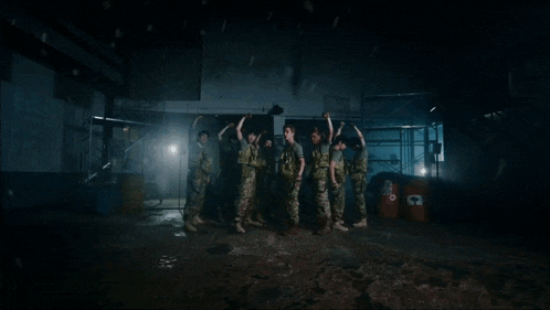 a group of men in military uniforms with one wearing a shirt that says ' army '