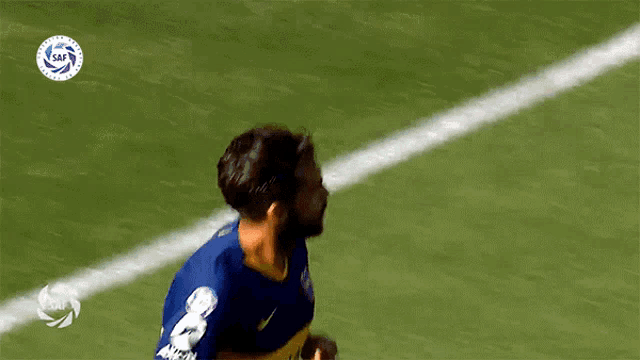 a soccer player wearing a blue shirt with the number 8 on it