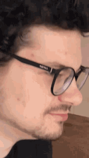 a close up of a man wearing glasses with the word pro on the lenses