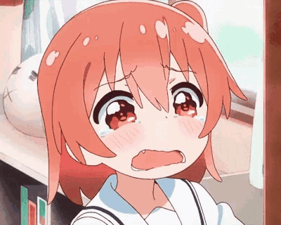 a girl with red hair is crying in front of a soccer ball