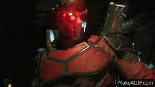 a man in a red suit is holding a gun in a dark room with makeagif.com at the bottom