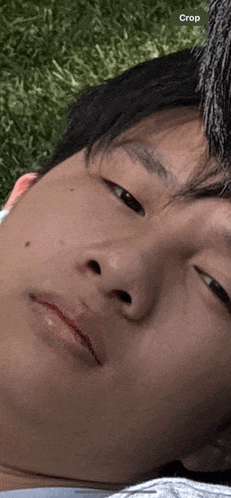 a close up of a man 's face with a crop button in the corner