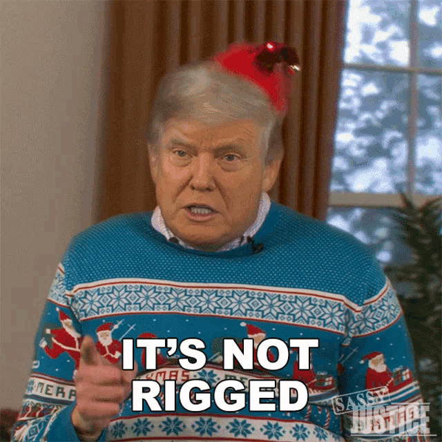 a man wearing a christmas sweater says " it 's not rigged "