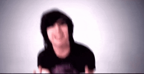 a blurry picture of a person wearing a hooded jacket and a black shirt .