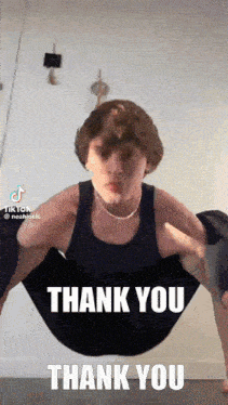a man in a black tank top is doing a yoga pose with the words thank you thank you