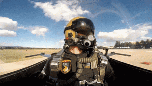 a man wearing a helmet and goggles has a patch on his chest that says ' rescue ' on it