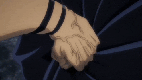 a person is holding another person 's hand with a tattoo on their wrist .