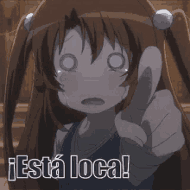 a girl with pigtails is pointing at the camera with the words " esta loca " below her