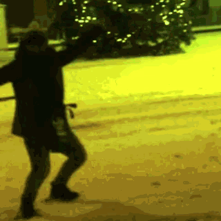 a silhouette of a person dancing in front of a yellow background