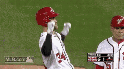 a baseball player with the number 34 on his jersey stands on the field