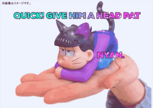a hand is holding a toy that says " quick give him a head pat "