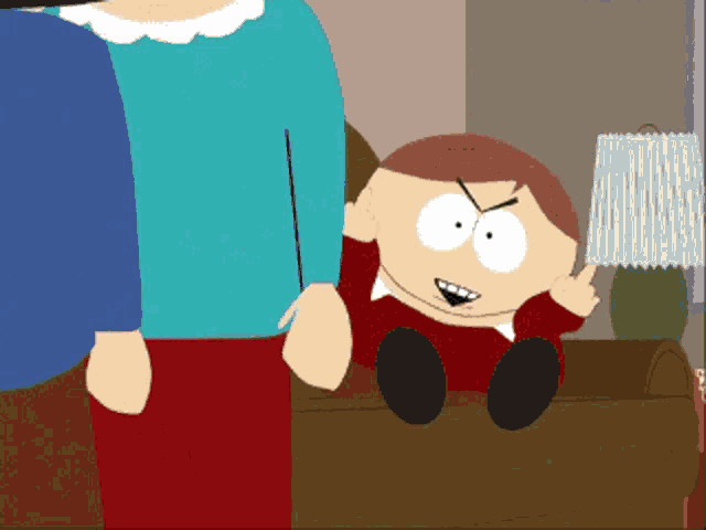 a cartoon character from south park is sitting on a couch and giving the middle finger