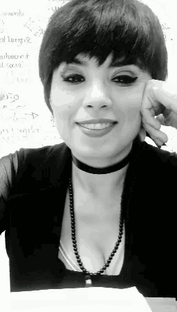 a black and white photo of a woman wearing a choker and a necklace