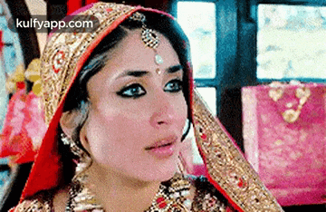 a close up of a woman 's face wearing a wedding dress and veil .
