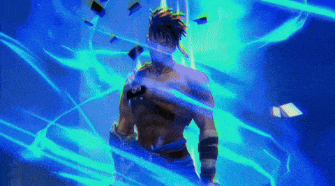 a man is standing in a dark room with a blue light behind him .