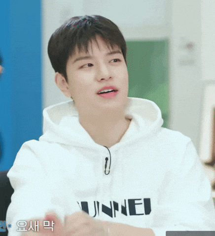a young man wearing a white hoodie that says ' unne ' on it
