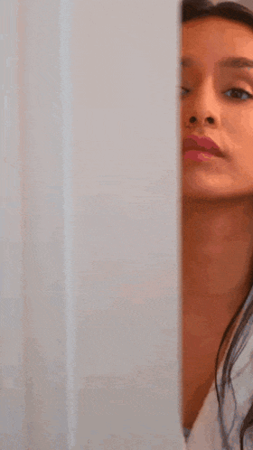 a close up of a woman 's face with a white robe on