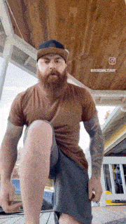 a man with a beard is doing a squat on a porch .