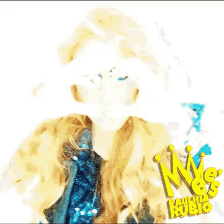 a woman is making a heart shape with her hands and the name paulina rubio is in the corner