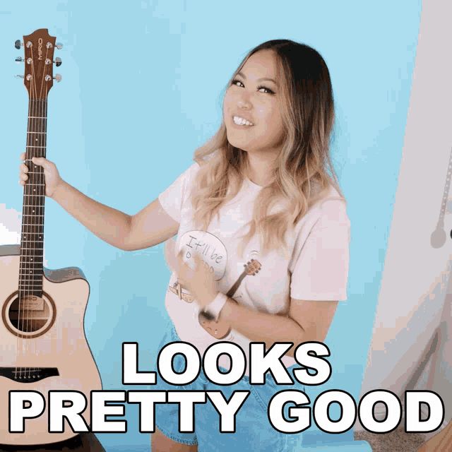 a woman holding an acoustic guitar with the words looks pretty good written below her